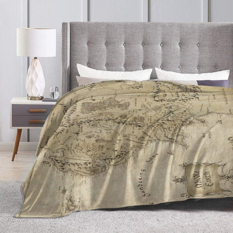 Bed with a map-themed comforter in a bedroom setting @chichicmart