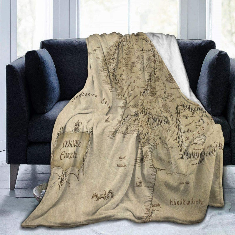 Map of Middle-earth blanket draped over a dark gray sofa. @chichicmart