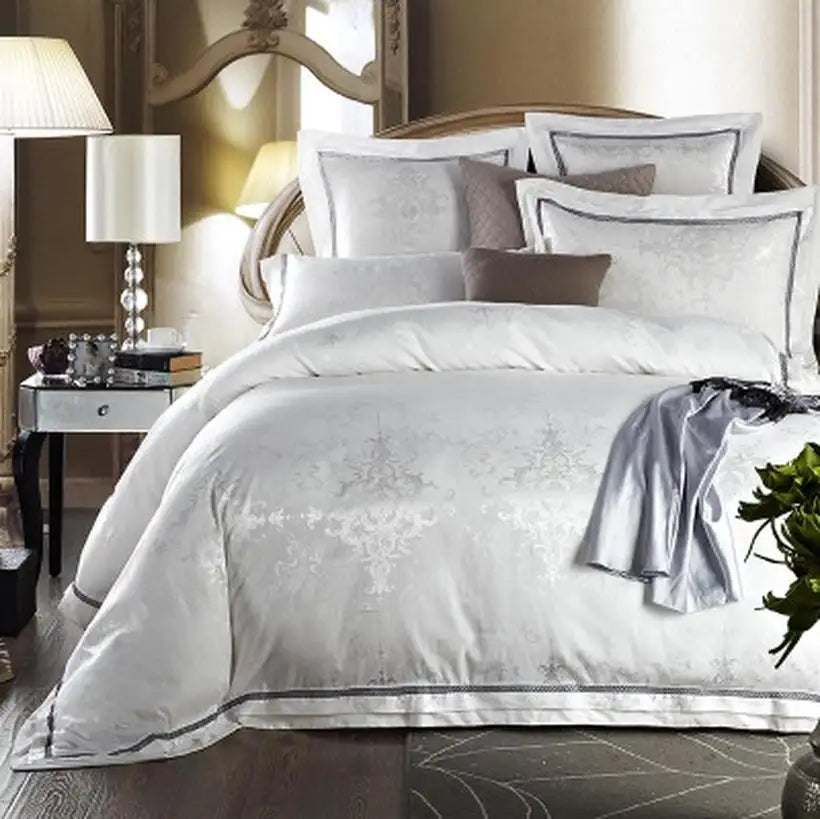 Neatly made bed with decorative pillows and a nightstand in a bedroom setting.