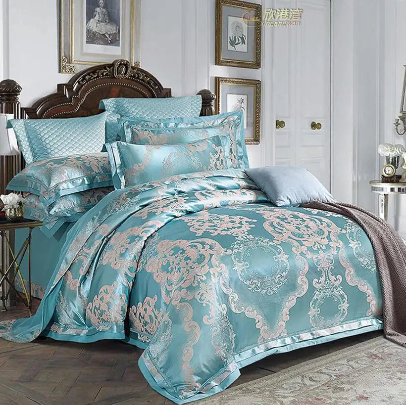 Turquoise and silver patterned bedding set on a bed in a bedroom.