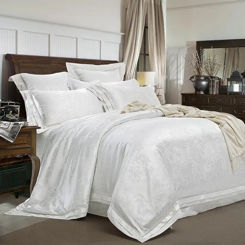 Neatly made bed with white bedding and pillows in a bedroom setting.