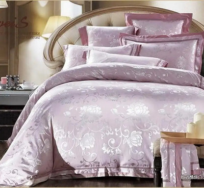 Pink floral bedding set on a bed with matching pillows.