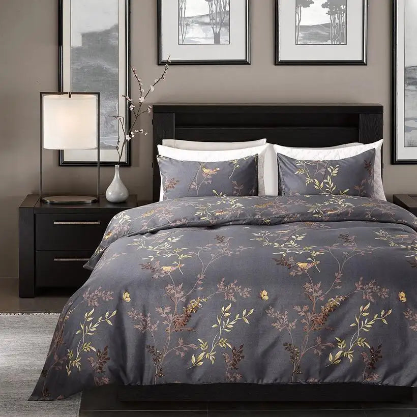 Bedroom with floral-patterned bedding on a bed, nightstands, and framed artwork on the wall.