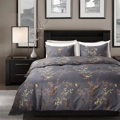 Bedroom with floral-patterned bedding on a bed, nightstands, and framed artwork on the wall.