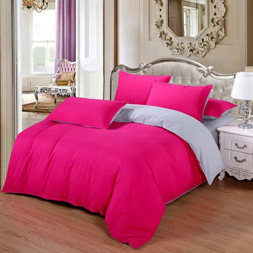 Hot pink bedding set on a bed in a bedroom with decorative elements.