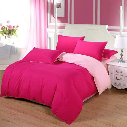 Bedroom with pink and red bedding set on a bed against a striped wall.