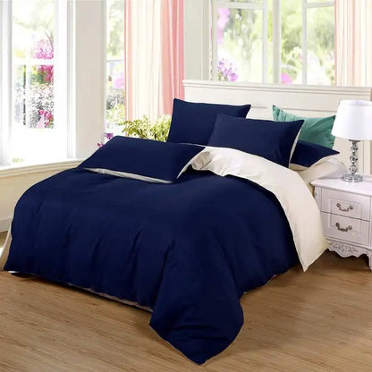Navy blue bedding set on a bed in a bright bedroom with floral curtains.