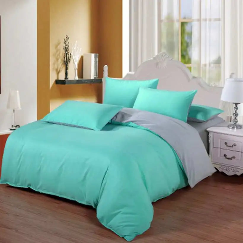 Turquoise bedding set on a bed in a well-lit bedroom.