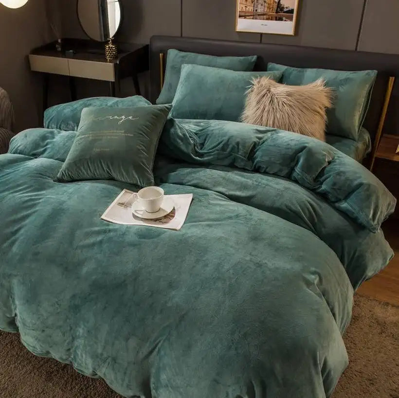 Teal comforter set on a bed with pillows and a cup of tea in a cozy bedroom.