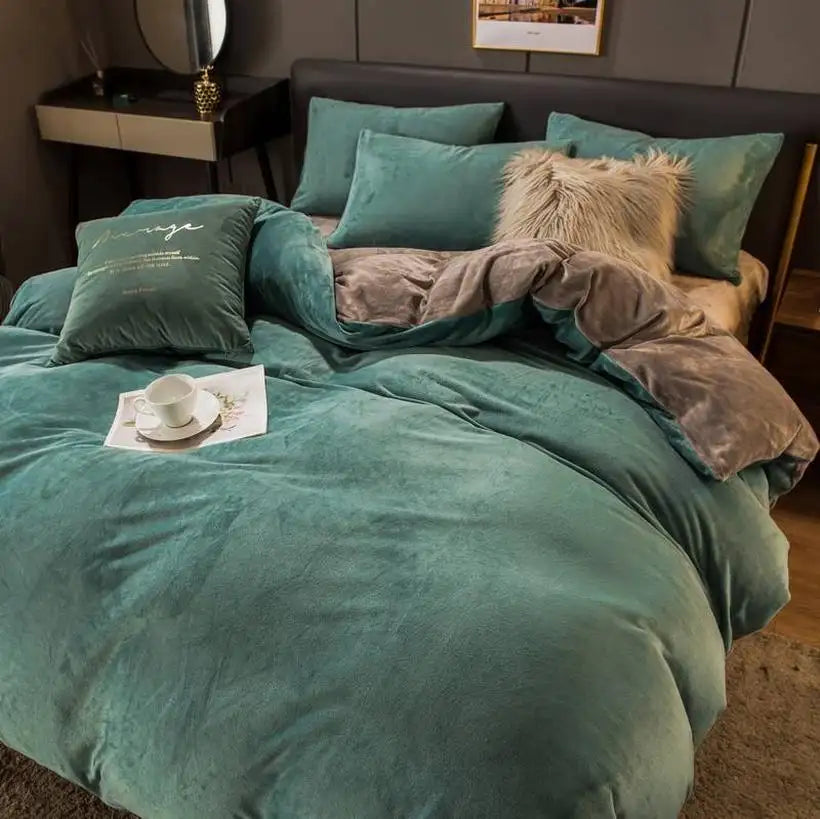 Teal bedding set with brown throw on a bed in a bedroom setting.