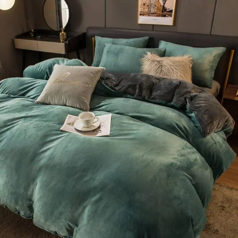 Teal comforter set on a bed with pillows and a cup of coffee in a cozy bedroom