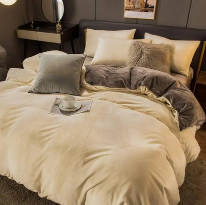 Neatly made bed with beige and gray bedding in a bedroom setting.
