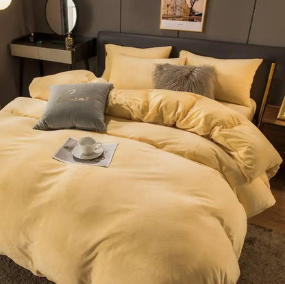 Yellow bedding set on a bed with gray pillows in a bedroom setting.