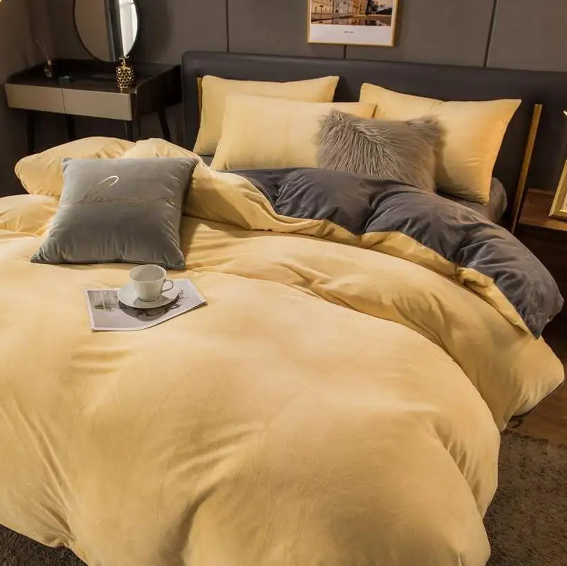 Yellow bedding set with gray pillows on a bed in a bedroom.