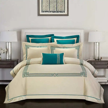 Neatly made bed with beige and teal bedding in a bedroom setting.