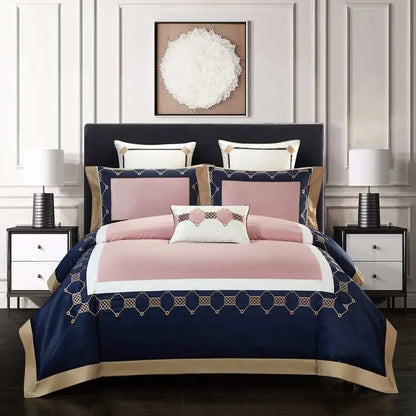 Navy and pink bedspread set on a bed with matching pillows in a bedroom setting.