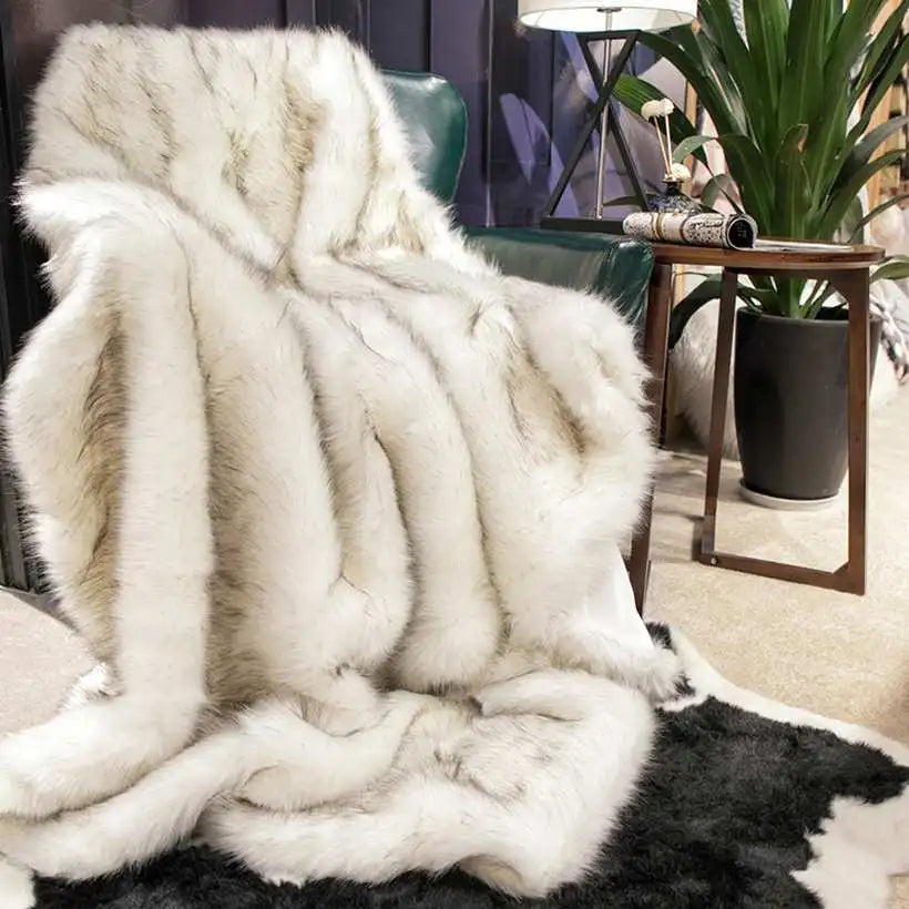 White fur throw blanket draped over a chair in a room with decor elements