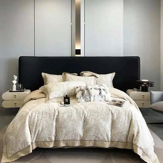 Neatly made bed with decorative pillows and a patterned comforter in a modern bedroom.