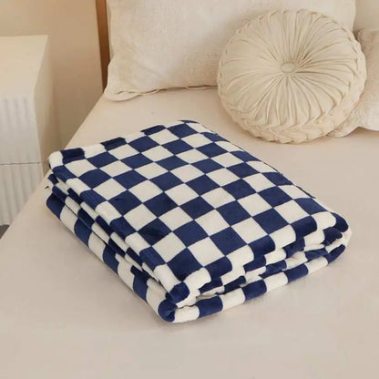 Blue and white checkered blanket on a bed with pillows