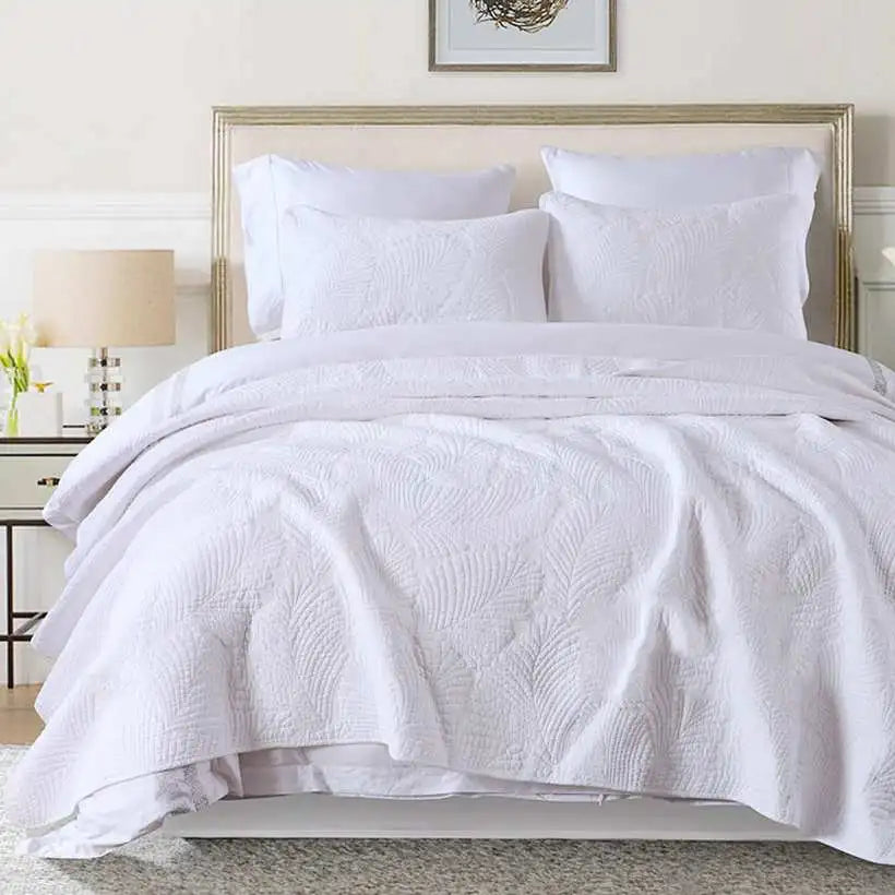 White textured comforter set on a bed in a bedroom setting