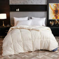 White comforter on a bed in a stylish bedroom with decorative elements.