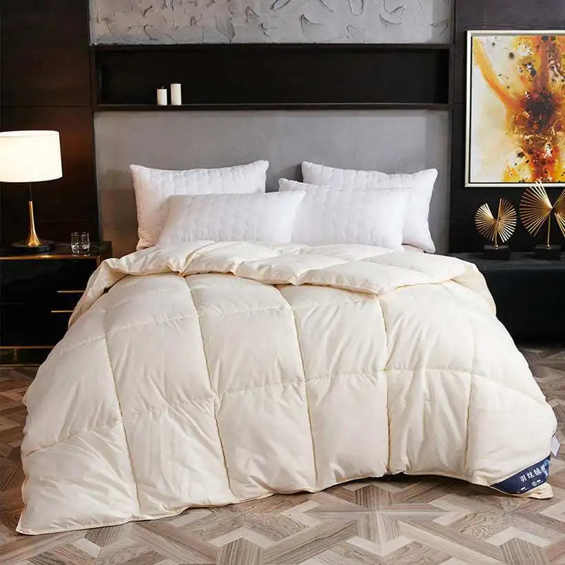 White comforter on a bed in a stylish bedroom with decorative elements.