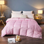 Pink comforter on a bed in a bedroom setting with lamps and decor.