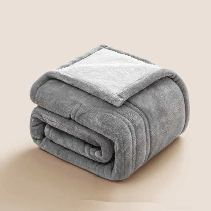 Folded gray blanket on a beige background