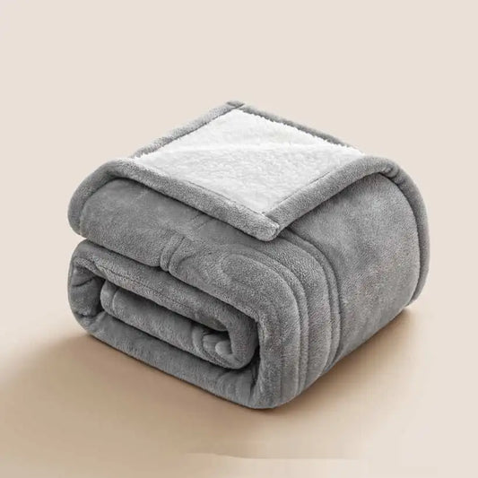 Folded gray blanket on a beige background