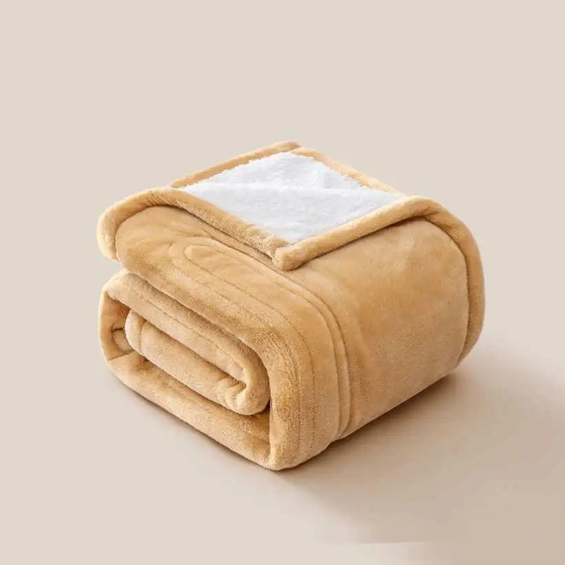 Folded beige blanket with white interior on a beige background