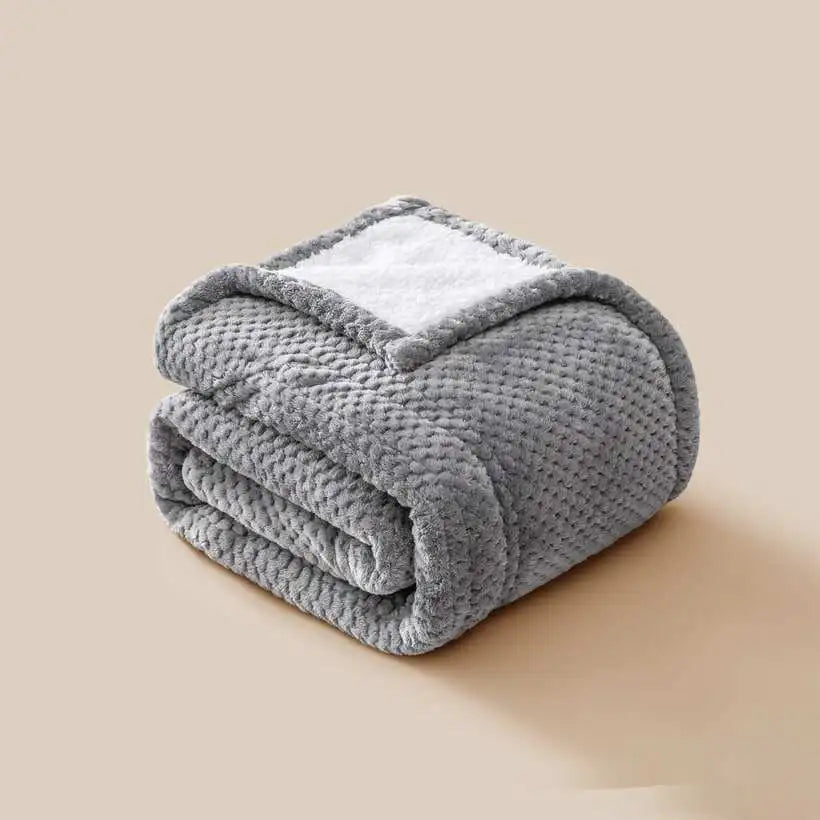 Folded gray blanket on a beige background